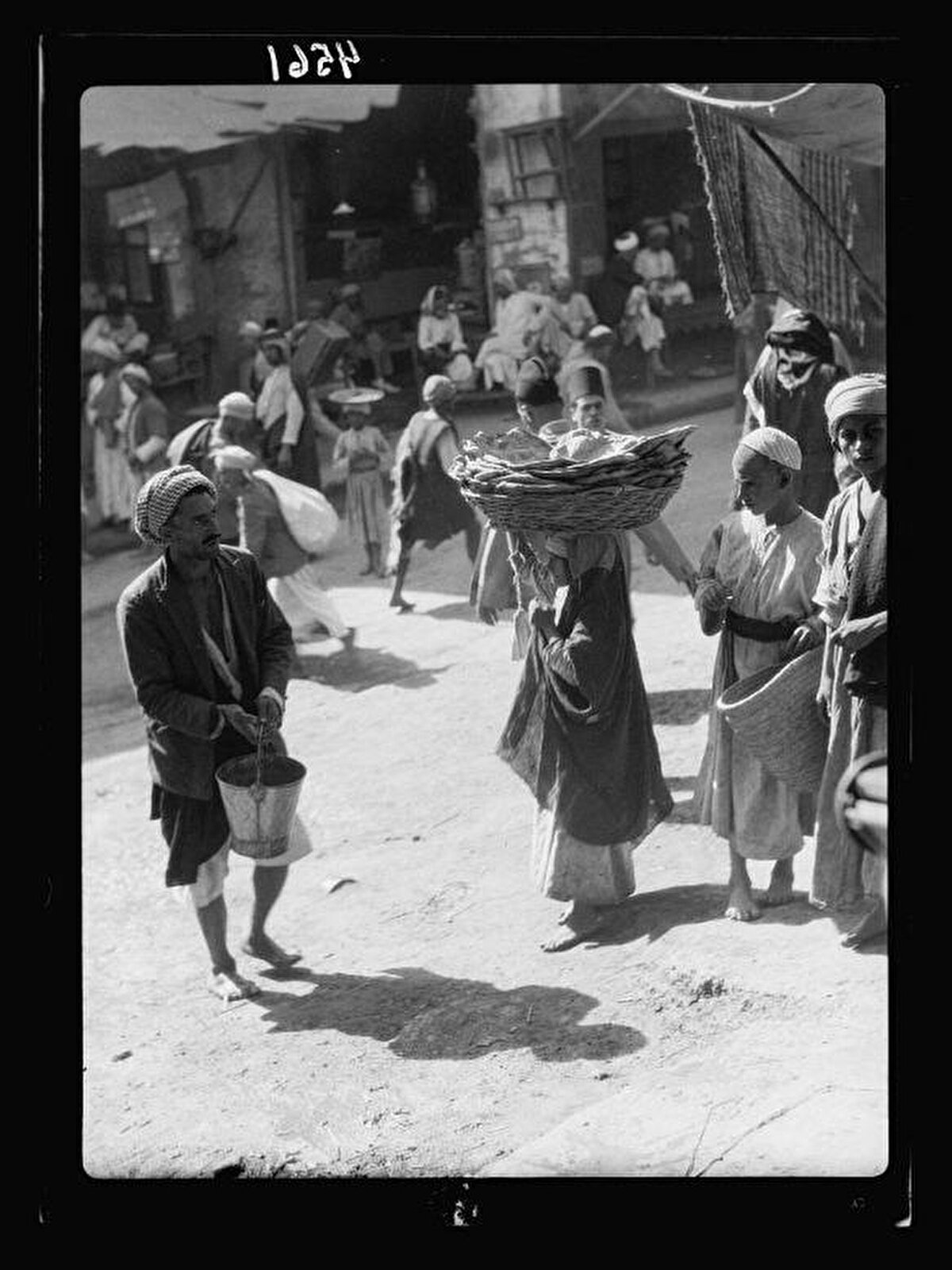 Pazar yerinde ekmek satan kız çocukları.