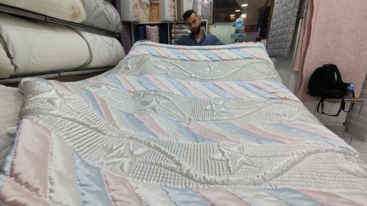 İpeği işlemenin çok zor olduğunu söyleyen Aslan, makinede yapılan yorganların el işçiliği olanların onda biri fiyatına satıldığını belirtti.