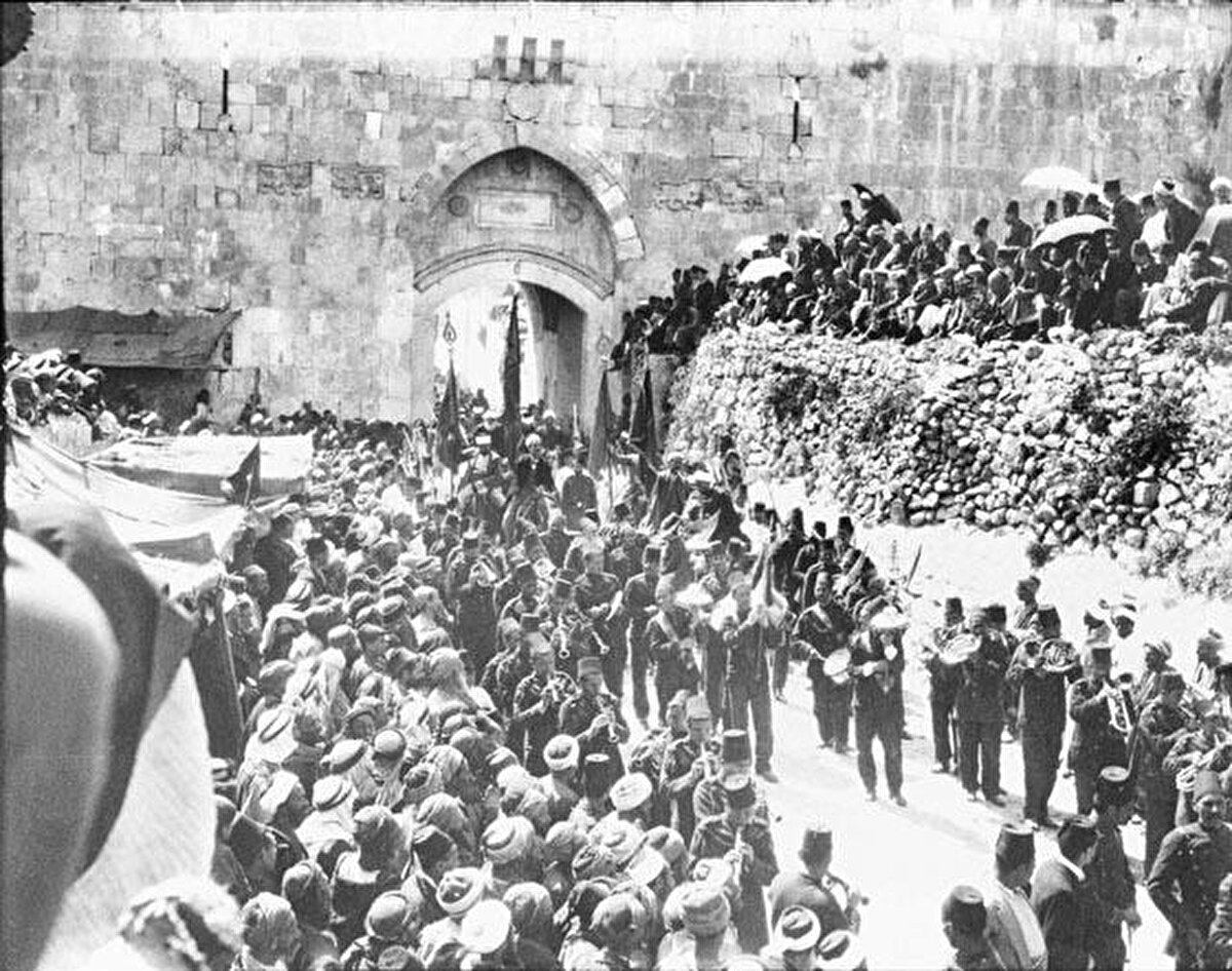 Eriha yönüne baktığı için “Eriha Kapısı”, Hz. Meryem’in dünyaya geldiğine inanılan mağaranın hemen yanında bulunduğu için “Sitti Meryem Kapısı” olarak adlandırılan, Batılıların “Aslanlı Kapı” adını verdiği kapının önünde düzenlenen Nebi Musa Şenlikleri, 1900. 