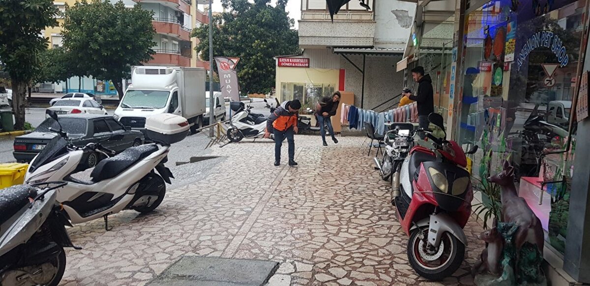 Vatandaşlar, dükkan altlarına sığınırken esnaf ise dışarı çıkarak kar topu oynadı.