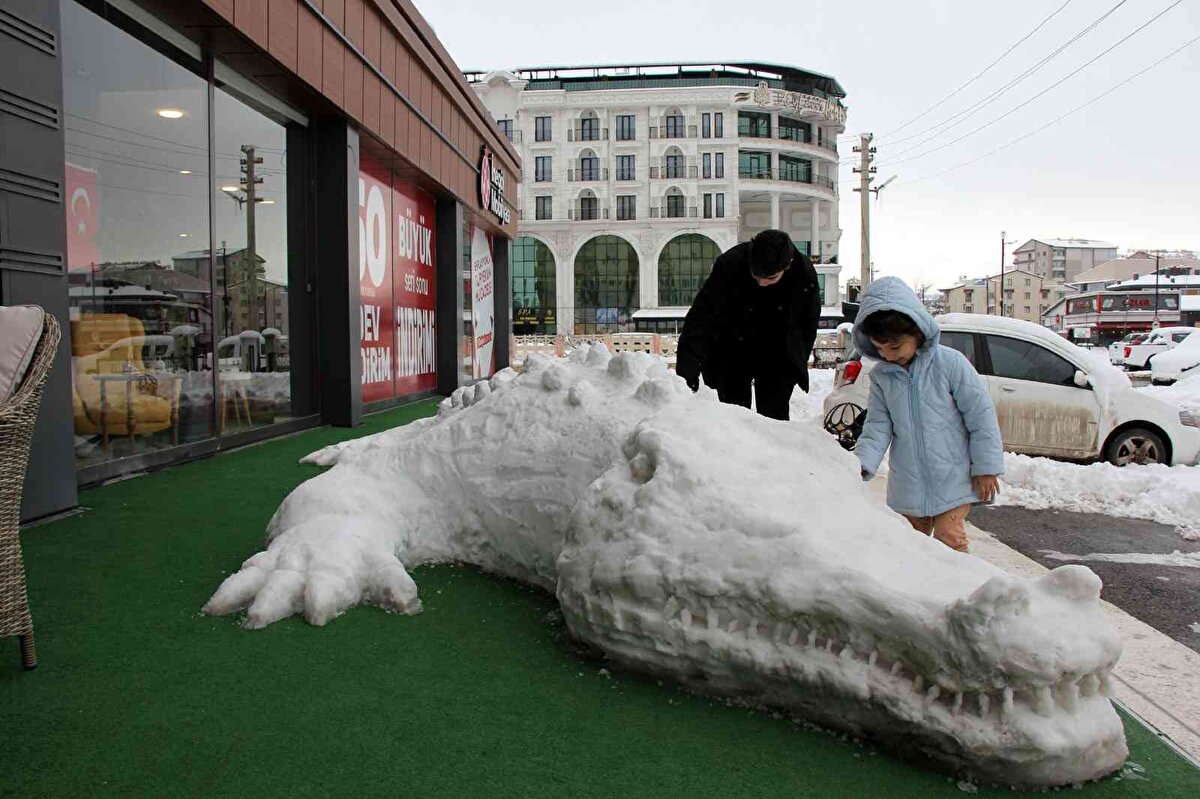 Sivas’ta geçtiğimiz akşam etkili olan kar yağışı kenti beyaza bürüdü. Kimileri karı eğlenceye çevirirken kimileri de sanata dönüştürdü. Kent merkezi Kardeşler Mahallesinde esnaflık yapan Ebru Karatutan ve çalışanları her yıl yaptıkları geleneği bozmadı. Geçtiğimiz yıl kardan Kangal köpeği yapan Karatutan ve çalışanları bu yılda kardan timsah yaptı. Yaklaşık 11 metre uzunluğundaki kardan timsahın yapımı 6 saat sürdü. İşletmenin önünde dev timsahı görenler şaşkınlıklarını gizleyemedi. Vatandaşlar anı ölümsüzleştirmeyi de unutmadı.<br>