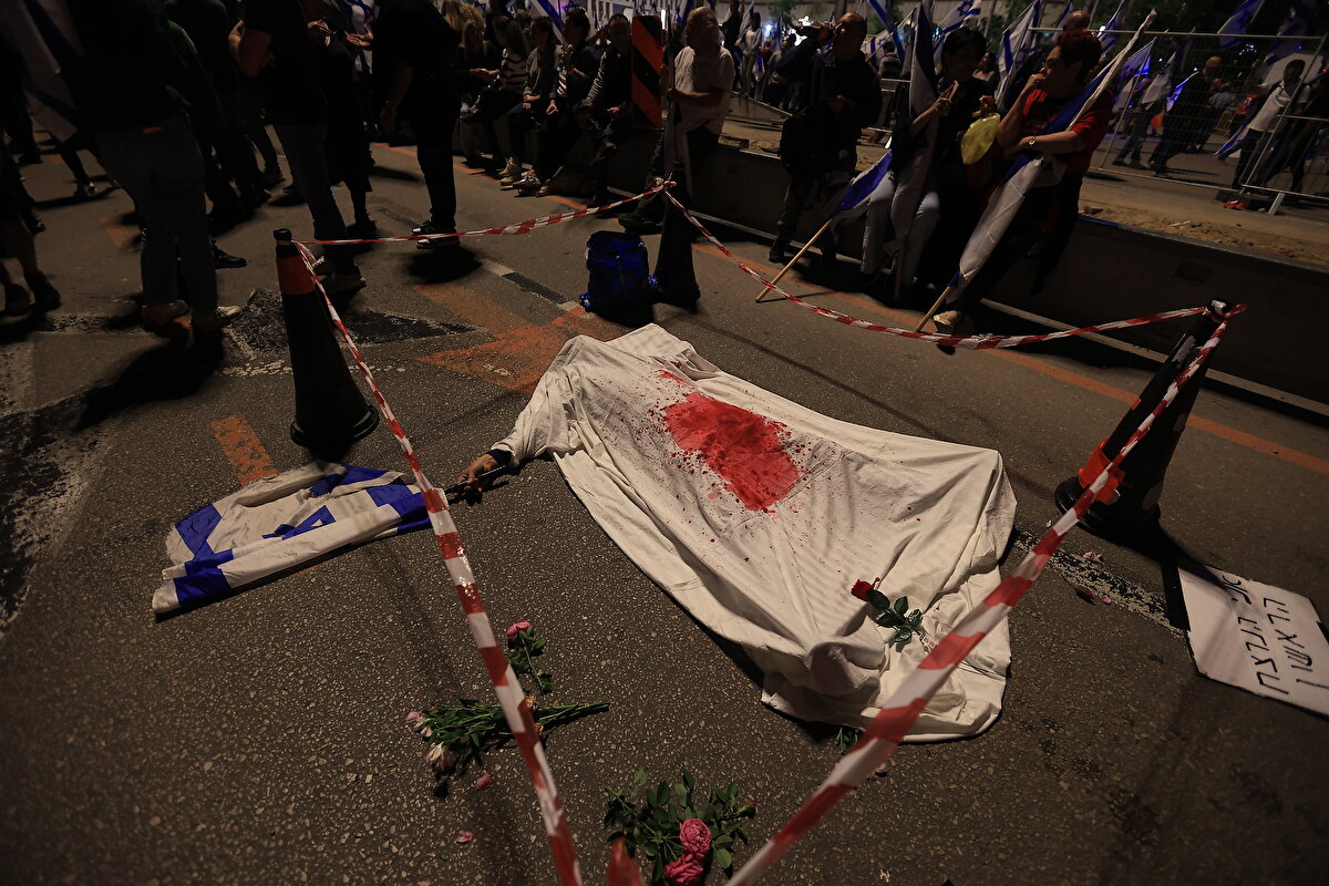 İsrail bayrakları taşıyan kalabalık Netanyahu ve hükümet karşıtı sloganlar attı..<br><br>Başbakan Netanyahu için açılan "Suç bakanı" pankartıysa dikkat çekti.