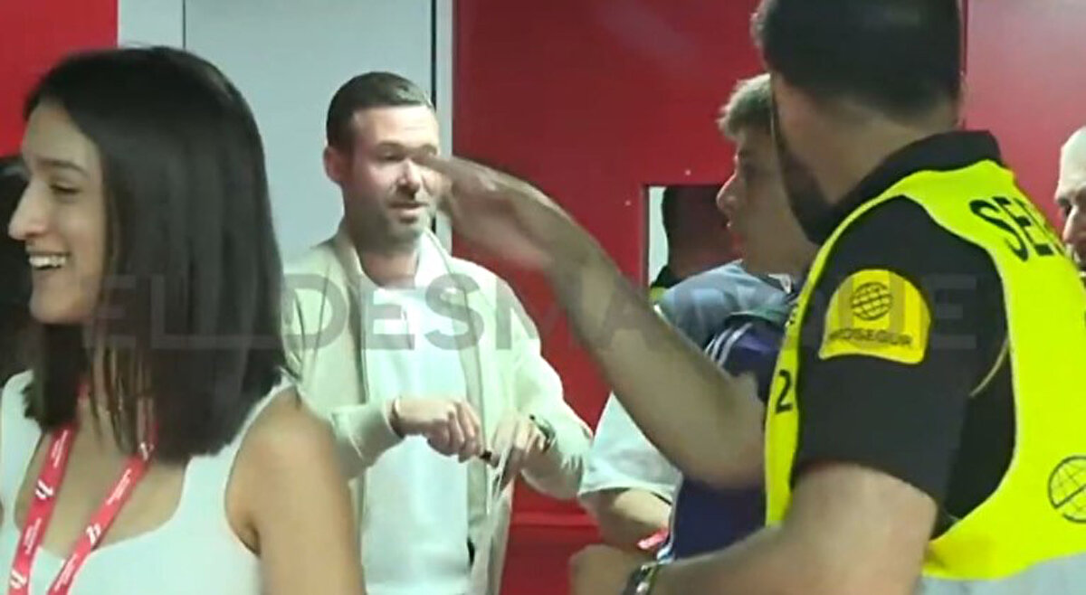 ElDesmarque'de yayınlanan fotoğrafta Arda Güler'i görevlilerin uyararak Real Madrid kafilesinin olduğu yeri gösterdiği an net şekilde gözüküyor.