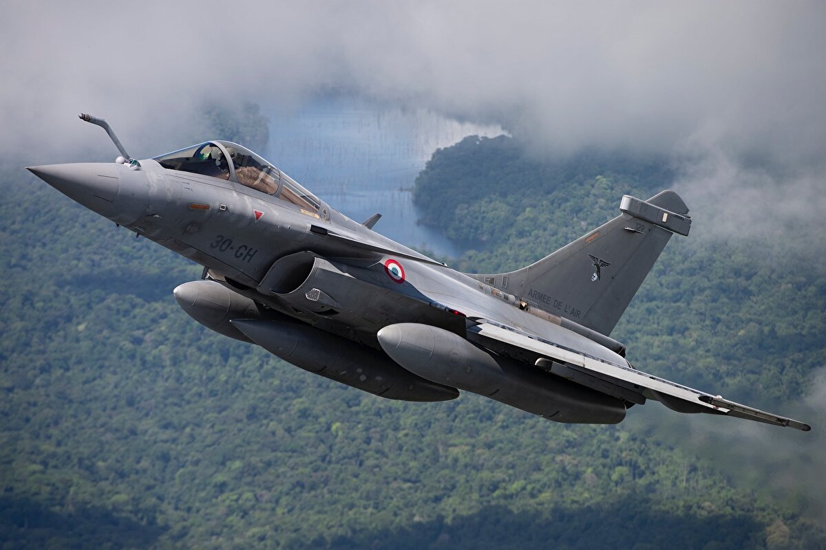 Rafale F4.1<br>Fransız Dassault firması tarafından üretilen Rafale, 1986 yılında ilk uçuşunu gerçekleştirmiş ve 2000 yılında hizmete alınmıştır. Aerodinamik yapısıyla öne çıkan Rafale, kanard delta kanatlı, çift motorlu, çok maksatlı bir savaş uçağıdır.<br><br>4.5 nesil Rafale savaş uçağı 2 adet Snecma M88-4E turbofan motorundan güç alır. Her bir motor 75 kN itiş gücü üretir. Kullanılan kompozit malzemeler ve kaplamalar sayesinde radar izi oldukça azaltılmıştır. Uçakta 200 km üzerinde menzile sahip RBE2-AA AESA radarı kullanılmaktadır. Bu sayede Meteor havadan havaya füzelerinin kullanım kabiliyeti kazanılmıştır. Rafale savaş uçaklarında bulunan en önemli sistemlerden biri de SPECTRA elektronik harp sistemidir. Bu sistem sayesinde radar kapalıyken düşman unsurları uzun mesafeden tespit ve teşhis edilebilmektedir. Tespit edilen yayınları karıştırması için 3 adet AESA anteni ve kendisine atılan füzeleri tespit etmek amacıyla 2 adet IR füze alıcısı ve lazer ikaz sistemi bulunur. Uçak üzerinde ayrıca IRST sistemi ve lazer mesafe ölçerden oluşan FSO (Front Sector Optronics) sistemi vardır. IRST ile 100 km’den fazla bir mesafede hava hedeflerinin teşhisi ve takibi yapılabilmektedir.<br><br>Rafale F3 savaş uçakları, ASMP-A nükleer saldırı füzesi Reco NG keşif podu ve MBDA AM-39 Exocet gemisavar füzesi taşıma yeteneğine sahiptir. Bu sayede Rafale çok rollü bir uçağa evrilmiştir. Bu model, lazer güdümlü Safran AASM ve Thales Tailos hedefleme podu eklenerek F3-R versiyonuna yükseltilmiştir. Halihazırda kullanılan Damocles poduna ait özelliklere ek olarak daha yüksek irtifa ve daha uzun menzilden gece ve gündüz operasyon yapma yeteneği, hareketli hedeflerin otomatik tespit ve takibi kabiliyetleri eklenmiştir. Ayrıca AGCAS otomatik zemin çarpışması kaçınma sistemi bulunmaktadır.