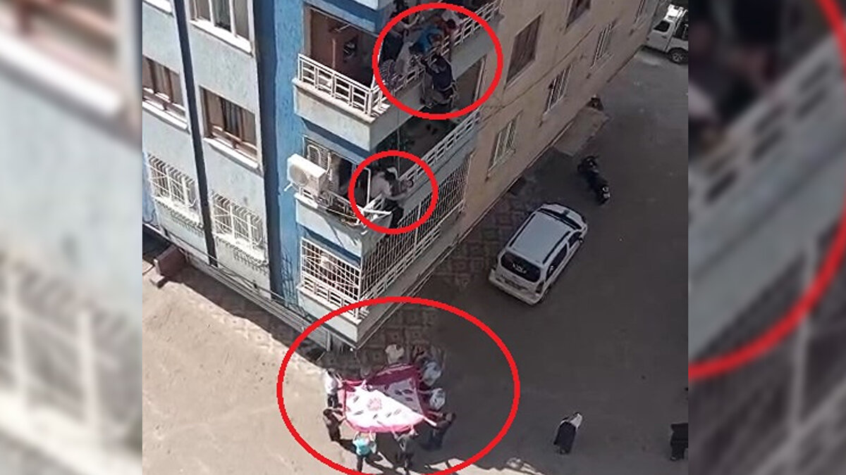 Diyarbakır'da düşme tehlikesi geçiren Down sendromlu çocuğu, komşusu iple sarkarak indiği balkondan kurtardı. O anlar cep telefonuyla görüntülendi.