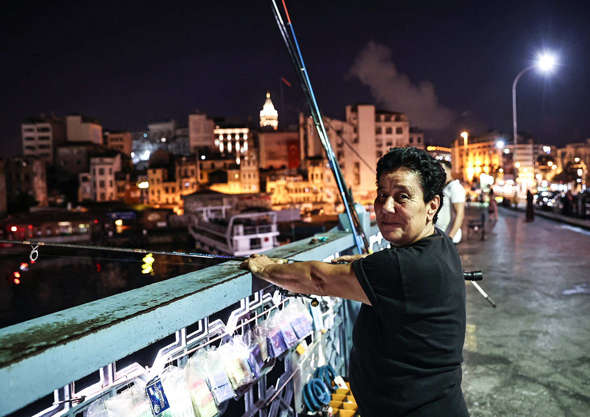 Fishermen catch fish at Galata Bridge in Istanbul