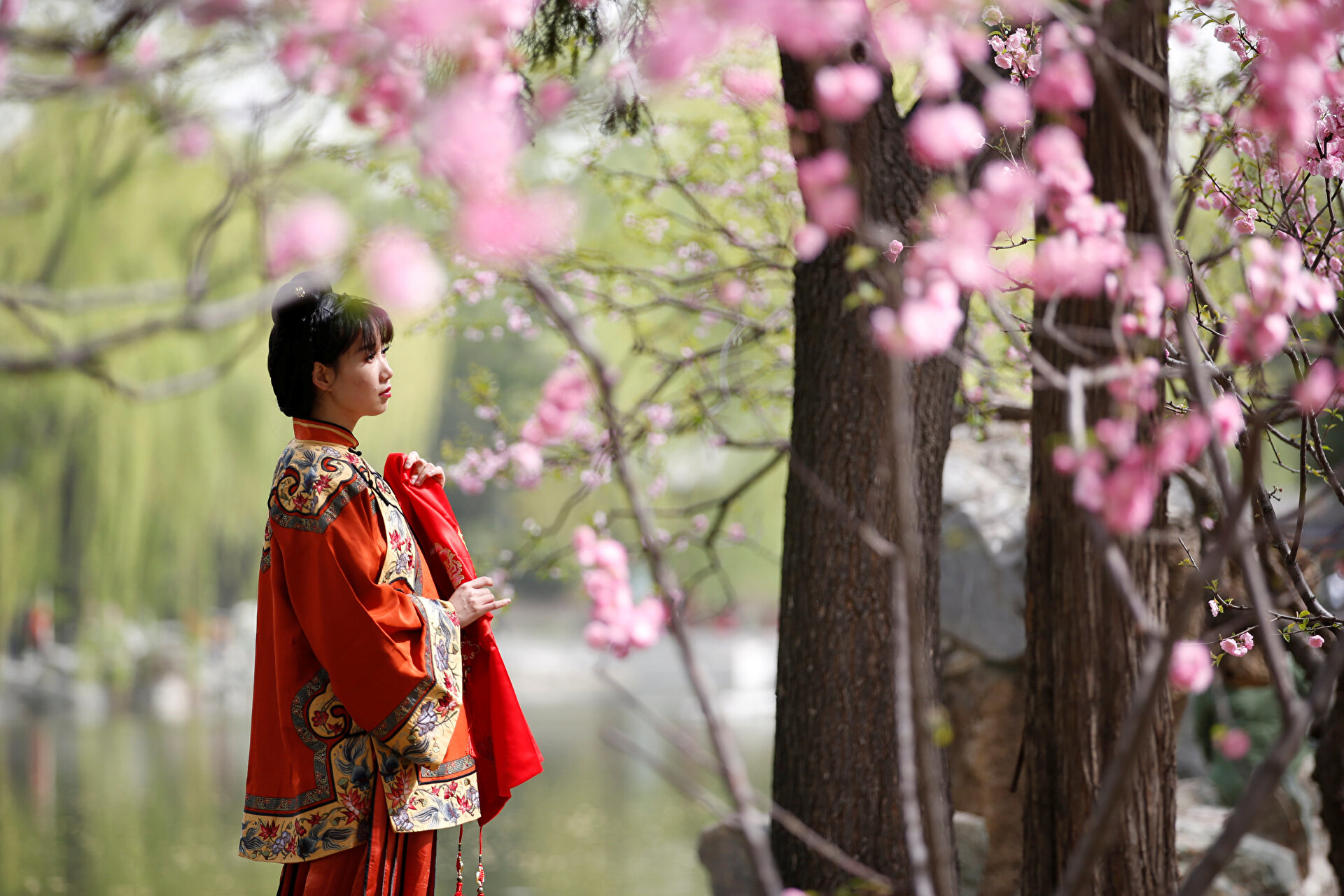 Women dressed in traditional costumes are seen during the Qingming tomb-sweeping festival in Beijing