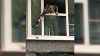 Sultangazi'de yürek ısıtan görüntü: Soğuktan titreyen kumruyu camdan uzattığı saç kurutma makinesiyle ısıttı