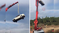 Vinçle tehlikeli çekim: Otomobili 30 metre yüksekliğe çıkardıkları sırada kadın ve çocuğun olması tüyleri ürpertti