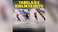 Fırtınada uçmasın diye tuttuğu tabelayla beraber metrelerce havalandı