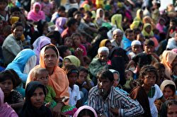 Rohingya refugees wait to receive permission from the Bangladeshi army to continue their way as they cross from Myanmar, in Teknaf, Bangladesh.