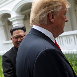 U.S. President Donald Trump and North Korea's leader Kim Jong Un walk together before their working lunch during their summit at the Capella Hotel on the resort island of Sentosa, Singapore, June 12, 2018. Reuters photographer Jonathan Ernst: 