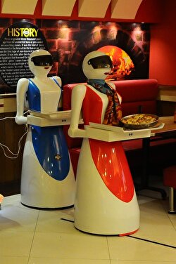 A robot waitress, which is built and developed by restaurant's owner's electrical engineer son Osama Aziz, services meal at a local fast food restaurant in Multan, Pakistan on July 08, 2017.
