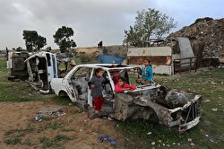 Children play around a junk car on a cold day in Khan Younis district of Gaza City, Gaza on January 05, 2018. Children of families, that live in makeshift tents, play around junk cars regardless of cold weather.