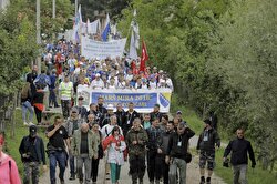 People attend the peace march on forest road known as death road, which was used by Bosnians who wanted to escape to Tuzla from Srebrenica massacre in 1995, in Potocari, Bosnia and Herzegovina on July 8, 2018.