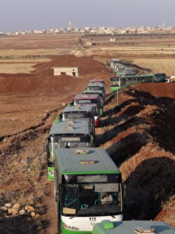 Buses are seen outside the villages of al-Foua and Kefraya, Syria.