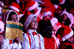 Children wearing Santa Claus caps sing Christmas carols in Pakistan's Karachi