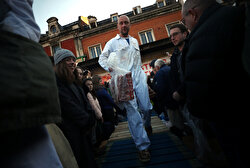 Butchers prepare to sell cuts of meat during a Christmas Eve auction in Smithfield market in London