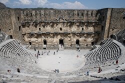 Tourists take photos at antique theatre of Aspendos, built by the Romans in 160-180 A.D, in Serik district of Antalya, Turkey on August 6, 2019. Aspendos, which is among the examples of the best designed Roman theaters, is one of the best-preserved ancient amphitheater and is still used for concerts and festivals.
