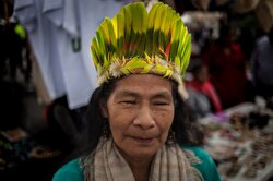 An indigenous woman of Colombian Amazon poses for a photo as she visits a market for cultural exchange in Bogota, Colombia on August 20, 2019.
