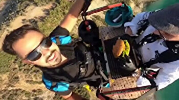 Forget pies in the sky: Turkish chef paraglides while making hamburger