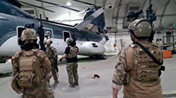 Taliban inspect Chinook helicopters left behind by US troops at Kabul airport hangar