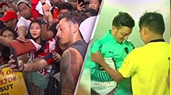 Arsenal fans gather to get captain Özil's autograph following PSG match