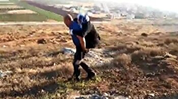 Turkish police carries injured Syrian woman on his back