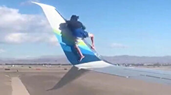 Man climbs plane wing, takes off shoes and socks in Las Vegas