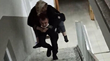 Turkish police conquers hearts by carrying old woman on his back up five floors