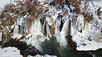 Turks take a dip in partly frozen Muradiye Waterfall