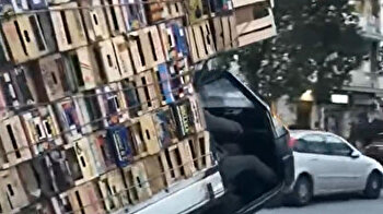 Resourceful man transports hundreds of wooden crates on tiny Tuk Tuk