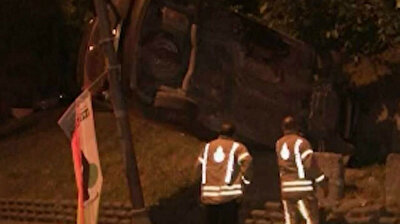 Car gets lodged between wall, lamppost after driver loses control of vehicle