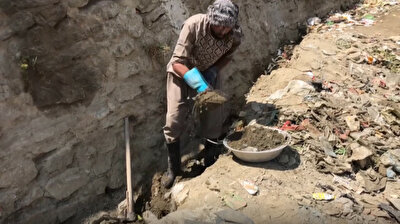 Afghan man digs river bed in search of gold for family's survival