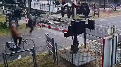 Irresponsible woman walking on train tracks narrowly avoids certain death in Netherlands