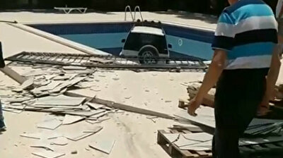 Out-of-control Jeep bursts through apartment complex, lands in pool in Antalya