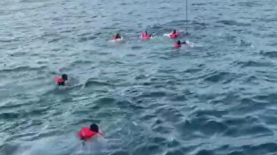 Desperate migrants jump overboard from charity boat off Italy