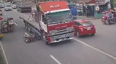 Heart-stopping footage shows motorcyclist narrowly avoiding being crushed by truck