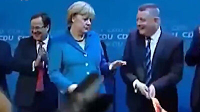 Funny video of Merkel chucking German flag to the side resurfaces