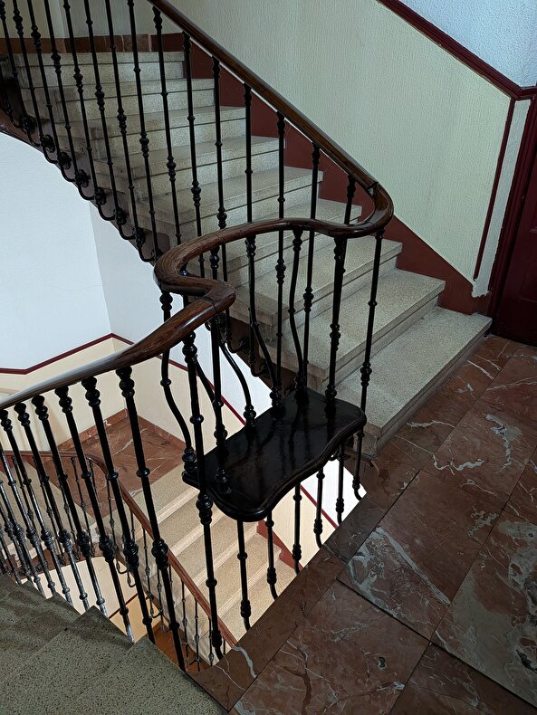 Eski bir apartmanın merdivenlerinde yaşlılar için yapılan dinlenme alanı