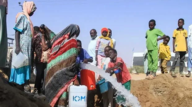 Des Soudanais qui ont fui El-Fasher, dans le Darfour, remplissent des jerrycans d'eau au camp de déplacés d'Al-Afad, dans la ville d'Al-Dabba, au nord du Soudan, le 21 novembre 2025. Depuis son déclenchement en avril 2023, la guerre entre l'armée soudanaise et les Forces de soutien rapide (RSF), une milice paramilitaire, a fait des dizaines de milliers de morts et près de 12 millions de déplacés. 
