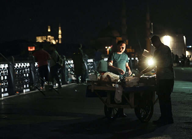 Fishermen catch fish at Galata Bridge in Istanbul