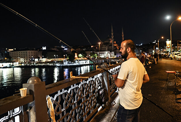 Fishermen catch fish at Galata Bridge in Istanbul