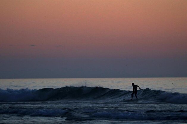 Californians enjoy sunset during low tide