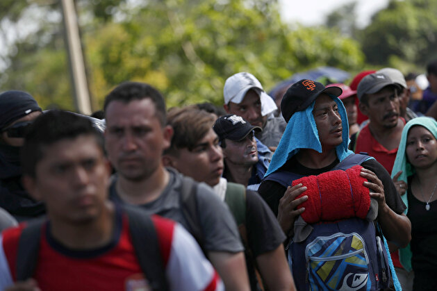 Migrant caravan traveling to US walks by road that links Ciudad Hidalgo with Tapachula