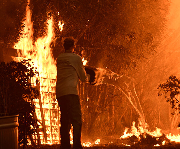Firefighters struggle to contain raging California wildfires