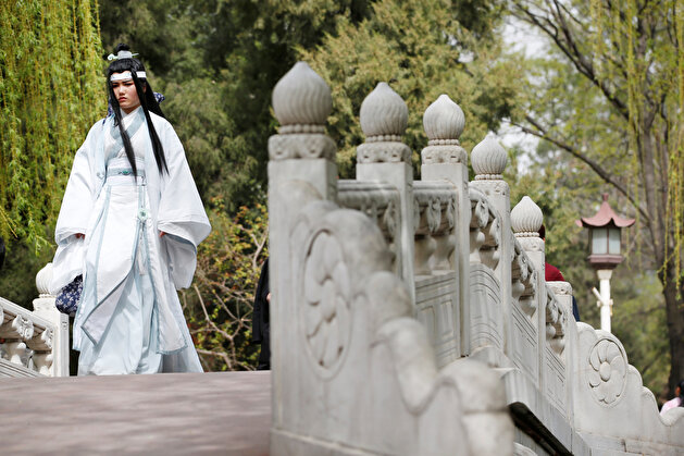 Women dressed in traditional costumes are seen during the Qingming tomb-sweeping festival in Beijing