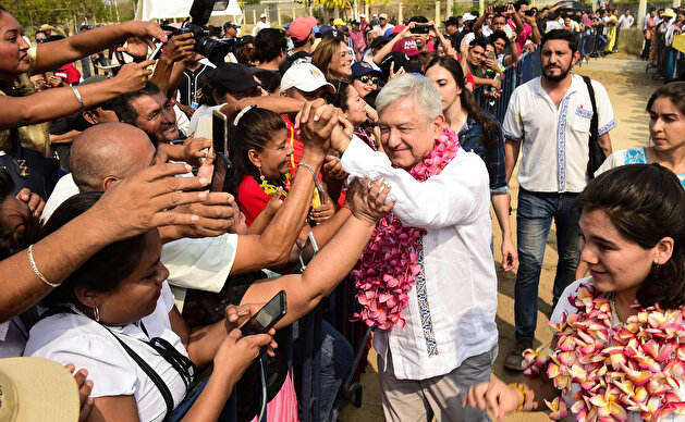 Mexico's President Andres Manuel Lopez Obrador greets a resident, in Juchitan de Zaragoza