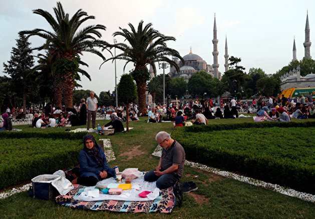 People have their iftar 'break fasting meal' at Sultanahmet Square during the holy month of Ramadan in Istanbul