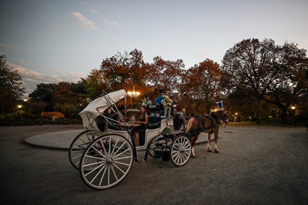 People enjoy autumn foliage at the Central Park in New York City
